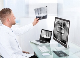 dentist examining a patient’s X-rays