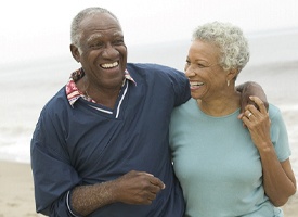 Older senior couple walking on the beach