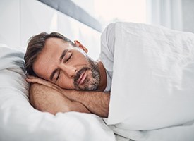 Man resting peacefully with help of sleep apnea therapy in Pittsburgh