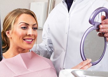 Woman looking at smile in mirror