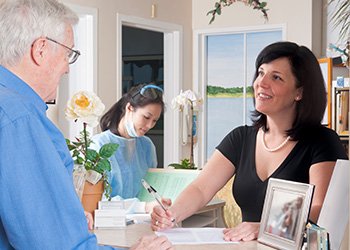 Man checking in at dental reception desk