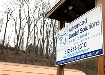 Male dental patient checking in at front desk