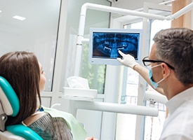 Dentist explaining to patient about advanced dental implant technology in Pittsburgh