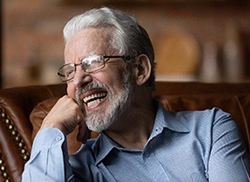 Man laughing on a couch