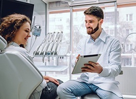 dentist showing a patient information on a tablet 