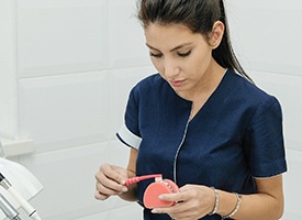 Dental assistant cleaning dentures. 
