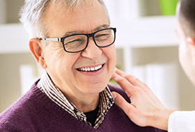 Smiling senior man in dental chair