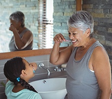 Woman brushing teeth in Pittsburgh