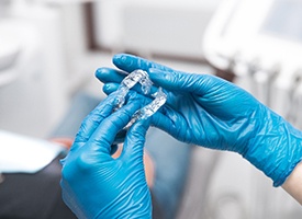 Dentist holding clear aligners
