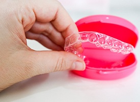 Clear aligners in a pink case
