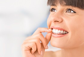 Woman inserting her Invisalign in Pittsburgh trays