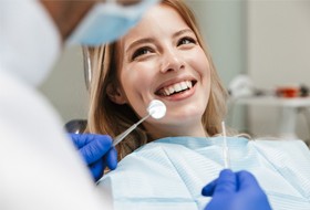 A woman with a straight smile in the dentist chair