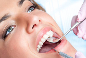 Closeup of female patient receiving dental exam
