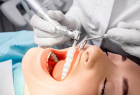Female patient receiving professional teeth cleaning
