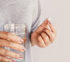 Woman taking a pill