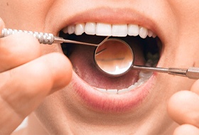 Dentist examining patient after full mouth reconstruction.