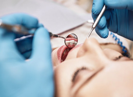 Close up of dentist cleaning a patient’s teeth