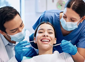 a patient smiling while getting her teeth checked