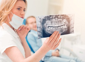 Dentist showing X-rays to patient