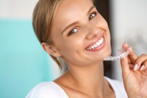 Woman holding Invisalign.