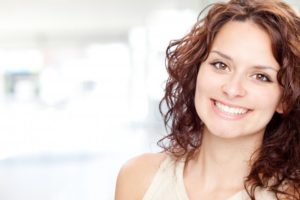 woman brown hair smiling perfect teeth