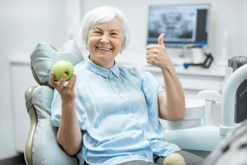 Woman smiling and giving a thumbs up