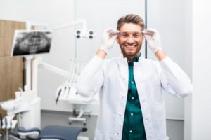  a specialist for dental implants in Pittsburgh putting on safety glasses