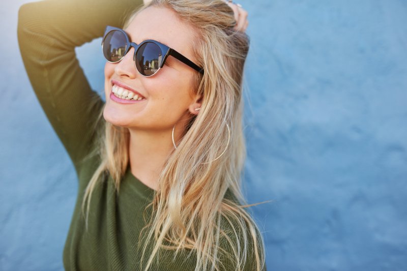 Cheerful woman smiling outside