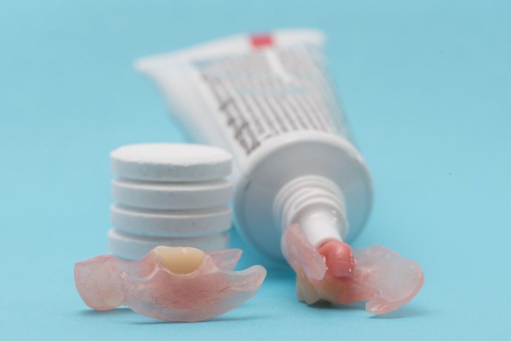 Dentures and denture adhesive paste